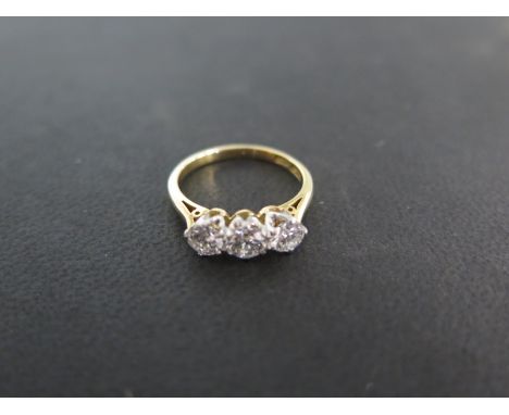 An 18ct yellow gold and platinum three stone diamond ring - each stone approximately 0.30ct ring - size L/M approximately 3 g