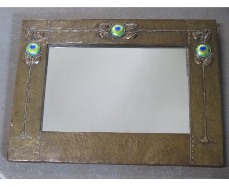 An Art Nouveau brass mirror with 'Peacock' enamel roundals in the liberty style - 46cm x 61cm - overall good condition - enam