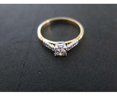 A yellow gold solitaire diamond ring size P - approx weight 2.8 grams - central diamond approx 0.21ct flanked either side by 