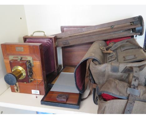 A French Merville 3/4 plate bellows camera with a No. 3 Berthiot lens, with a tripod, carry case two plate holders and anothe