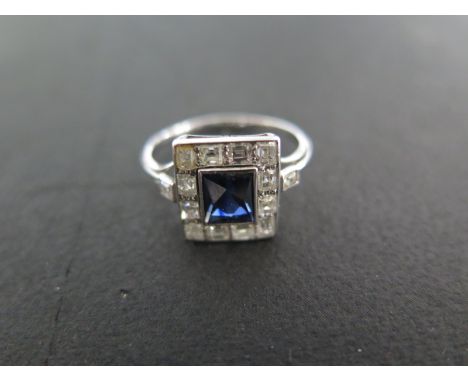 A white metal Art Deco style sapphire and diamond ring - size L - approximately 2.8 grams - the central sapphire measures app