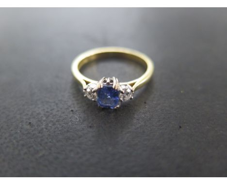 An 18ct yellow gold sapphire and diamond ring size N/O - approx weight 3 grams - sapphire approx 5mm x 4mm - overall good con