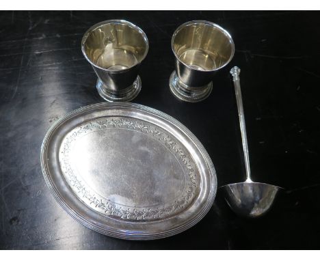 A silver hallmarked ladle - mark for London 1936-37, a small oval tray with foliate engraving - raised on four feet, mark for