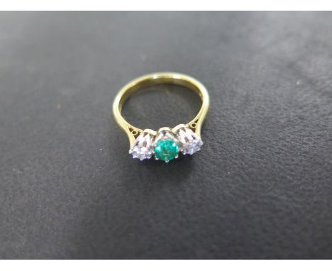 An 18ct yellow gold diamond and emerald ring - size L/M - approximately 2.7 grams - emerald approximately 5mm diameter - good