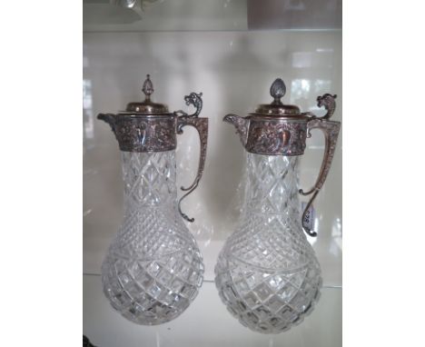 A pair of glass hobnail and diamond cut claret jugs with plated mask tops - Height 31cm - good condition, some wear to plate