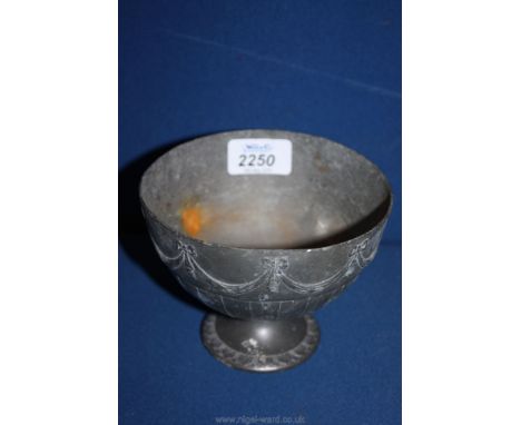 A footed Pewter Bowl, the body decorated with bows and swags and with striped detail below, 5 1/8" diameter, 4 1/8" high, mar