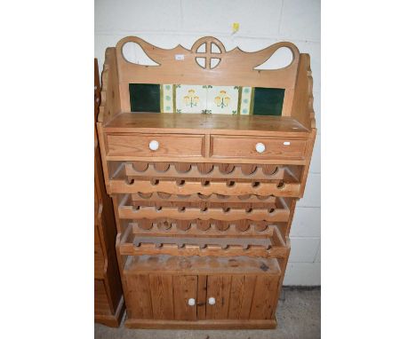 PINE TILE BACK SIDE CABINET WITH INTEGRAL WINE RACKS AND COVERED BASE