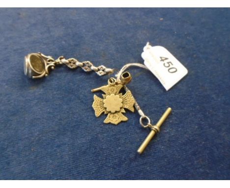 A silver 3 sided revolving fob and silver chain with a gold miniature pipe and a floral cross  