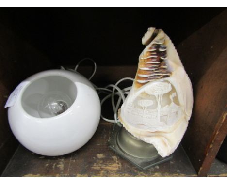 A cameo carved conch shell lamp and globe lamp