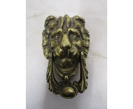 A brass lion face door knocker 20cmL