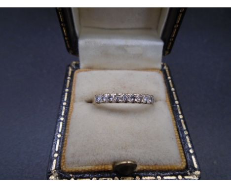 A 9ct gold ring set with 9 diamonds size M, 1.3g gross weight.