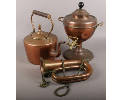 A copper samovar along with a copper kettle and bugle.  