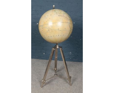 A decorative globe on stand. With chrome extending supports.  