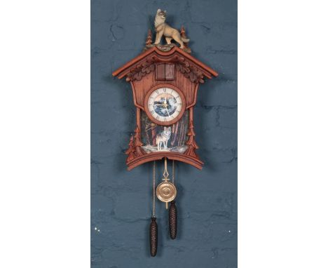 A Chalet style composite and wood Cuckoo clock. Decorated with wolfs by The Bradford Exchange. Limited edition no No A1148.  