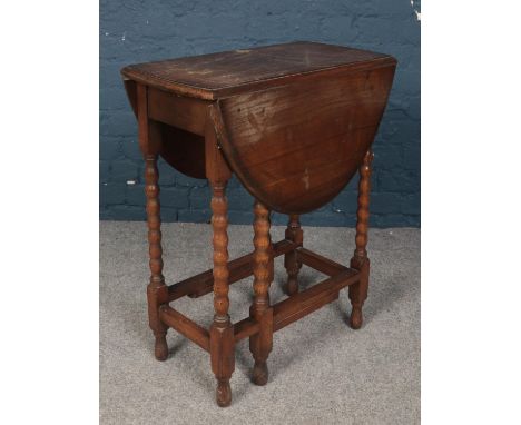 A small oak drop leaf table. With bobbin turned supports.  