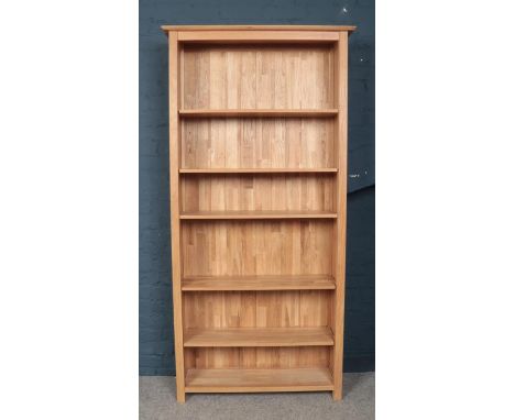 A large light oak open bookcase.  