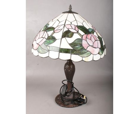A large Tiffany style table lamp. With floral shade and metal base.  