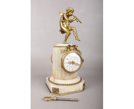 An Alabaster mantle clock with gilt metal boy with pipes. Comes with key. H: 25cm, W: 11cm.  Condition fair. Some attention i