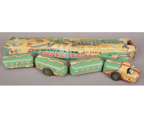 A TN Nomura tin plate and friction drive model of a snake train, comprising of four various articulated sections, housed in t