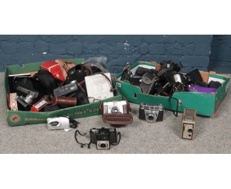 Two boxes of assorted cameras. Kodak Brownie 13mm, Ilford Sportsman, Lumix, Olympus etc  