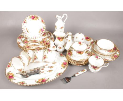A Thirty-Five Piece Royal Albert Country Roses Dinner Set. Includes Teacups and Saucers, Salt and Pepper pots and milk jug an