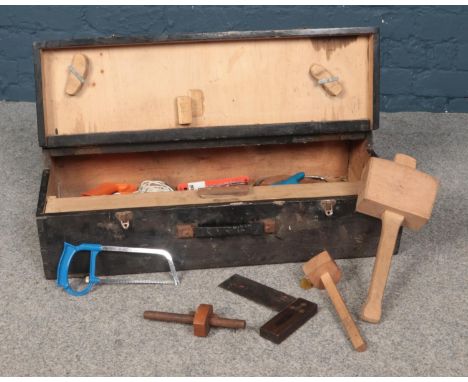 A vintage wooden box of hand tools.  