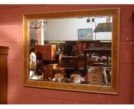 A large rectangular bevelled wall mirror.
