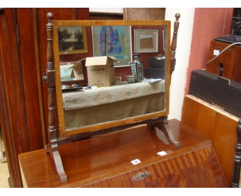 An early 19th Century mahogany rectangular skeleton swing toilet mirror, on turned upright supports. 