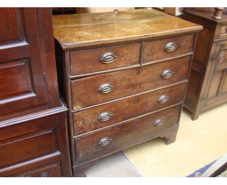 An early 18th Century joined oak chest of drawers, the two plank top over two short and three long graduated drawers with lat