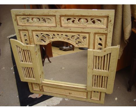 An Indian (Eastern) mirror window framed with foliate panels and doors. 