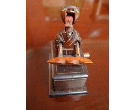A Japanese Kobe carved wooden automaton toy of a man eating a piece of watermelon. 