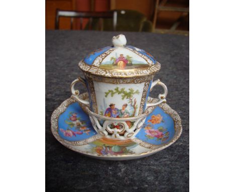 An early 20th Century Dresden porcelain  twin handled trembleuse chocolate cup, cover and saucer, underglaze blue crown mark,