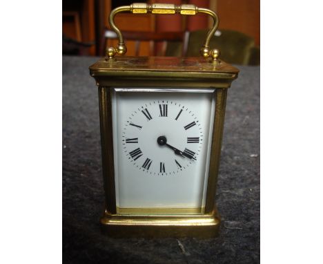 A brass carriage clock. 
