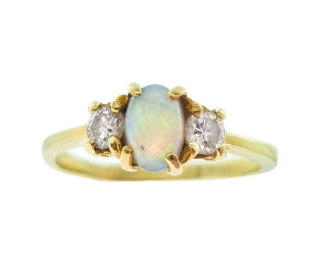 A 14ct white opal and diamond three-stone ring. The oval opal measures 6 x 4.2mm, flanked by two round cut diamonds of 0.15ct