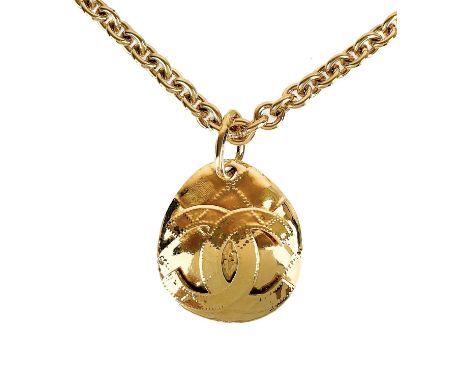 A Chanel 24ct gold-plated oval quilted CC pendant necklace, circa 1994. The pendant with oval plaque stamped 94 P, height of 