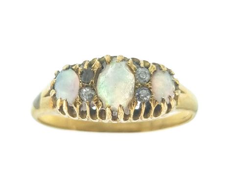 A Victorian high purity gold (tests 18ct) opal and diamond set ring. Set with three oval white opals showing multiple colours