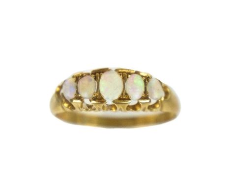 An early 20th century 18ct opal set five-stone ring. The boat shaped ring set with five oval graduated opals, stamped 18, siz