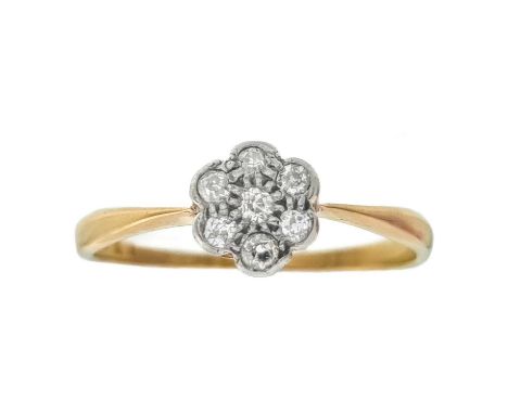 An 18ct diamond set seven-stone daisy ring. Stamped 18c, size P 1/2, 1.6g.