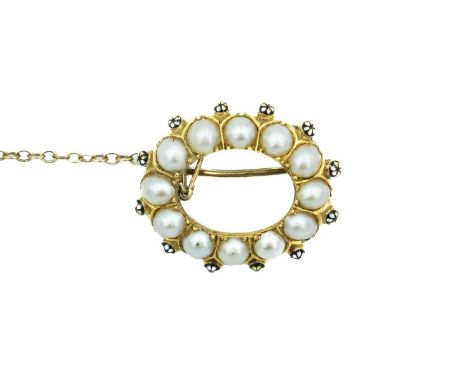 A 19th century high purity gold pearl and enamel annular brooch. The oval open brooch set with 12 split pearls, with outer bl