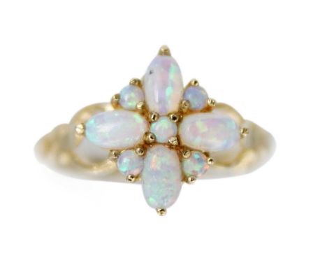 A 9ct opal set nine-stone ring. The head of cross design, the opals showing blue, green and orange colours, Birmingham hallma