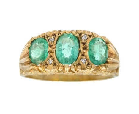 A 9ct Victorian-style emerald three-stone ring. The central oval emerald measuring 6.1 x 4.5mm, with four small diamond point