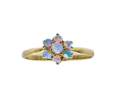 A 9ct opal set daisy ring. The opals showing blue, green and orange colours, size O, 1.2g.