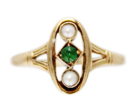 A 14ct pearl and green stone set ring.  With central lozenge millegrain set green stone flanked by split pearls in an oval op