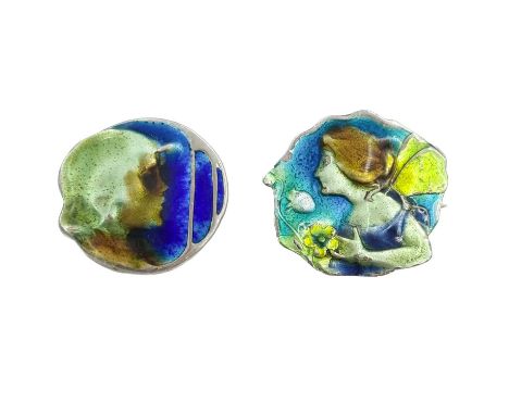 Two Art Nouveau silver and enamel brooches. One cast with a fairy in profile, monogramed RF, width 24mm, the other with a pro