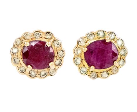 A pair of 14ct ruby and diamond cluster stud earrings. The oval cut rubies of 5.9 x 5mm, each surrounded by 13 small round cu