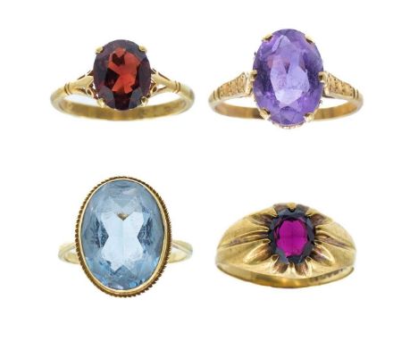 A selection of four gem-set dress rings. One set with a large blue topaz, size P 1/2; another with an amethyst, size T 1/2, a