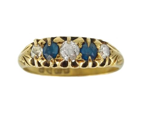 An Edwardian 18ct diamond and sapphire set five stone ring. With round cut graduated stones, the largest diamond 0.20ct appro