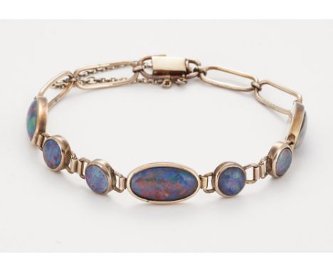 A COMPOSITE OPAL BRACELET, alternating oval and round opal-set links to an oval link bracelet. Length 18cm, 10.7 gramsCONDITI