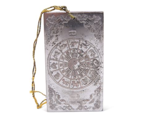 A CHINESE WHITE-METAL PLAQUE, rectangular, decorated in low relief with two dragons chasing a flaming pearl and Zodiac wheel.