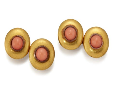 A PAIR OF CORAL DOUBLE CUFFLINKS, oval heads inset with oval coral, connected by figure-of-eight links. Heads 1.5cm by 1.2cm,